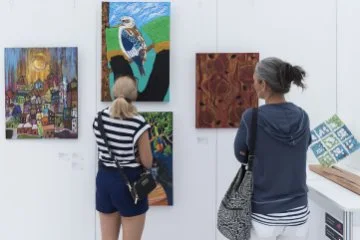 Photo of people browsing an art exhibition